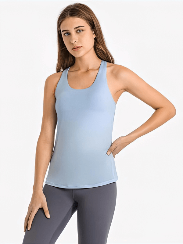 Sporty women's top with open back and cross straps, stylish and comfortable design for yoga or exercise.